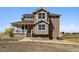 Lovely home with a welcoming front porch, complemented by well-maintained landscaping at 1212 N County Road 125, Bennett, CO 80102