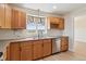 Well-lit kitchen features wooden cabinets, stainless steel appliances, and a sink with backyard views at 1212 N County Road 125, Bennett, CO 80102