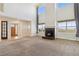 Expansive living room showcasing a grand fireplace, abundant natural light, and neutral tones at 1212 N County Road 125, Bennett, CO 80102