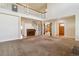 Open-concept living area with a piano, staircase, and a view of multiple rooms at 1212 N County Road 125, Bennett, CO 80102
