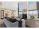 Bright and airy living room featuring soaring ceilings, a cozy fireplace, and large windows at 1212 N County Road 125, Bennett, CO 80102