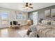 Comfortable primary bedroom with cozy decor, ensuite door, and access to a private outdoor patio at 1212 N County Road 125, Bennett, CO 80102