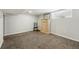 Finished basement with carpet, light colored walls and a dresser for storage at 4059 Quivas St, Denver, CO 80211