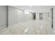 Spacious basement with tile flooring, utility access, and plenty of natural light at 4059 Quivas St, Denver, CO 80211