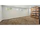 Spacious basement with new carpet, shelving for storage, and windows for light at 4059 Quivas St, Denver, CO 80211