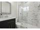 Beautiful bathroom with marble tile throughout, glass enclosed shower and updated fixtures at 4059 Quivas St, Denver, CO 80211