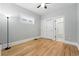 Bedroom with hard wood floors, a large window, closet and an attached bathroom at 4059 Quivas St, Denver, CO 80211