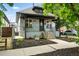 Charming home showcasing a covered front porch and beautiful flowerbeds at 4059 Quivas St, Denver, CO 80211