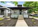 Charming home featuring a covered front porch and mature landscape at 4059 Quivas St, Denver, CO 80211