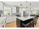 Stylish kitchen featuring an island with seating, stainless steel appliances, and ample counter space at 4059 Quivas St, Denver, CO 80211