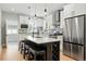 Modern kitchen with stainless steel appliances, island seating, and stylish lighting at 4059 Quivas St, Denver, CO 80211