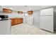 Spacious laundry room with tile floors, stainless steel appliances, cabinets, and a sink at 4059 Quivas St, Denver, CO 80211