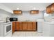 Bright laundry room with laundry machines, tile floors, a sink, and cabinets at 4059 Quivas St, Denver, CO 80211