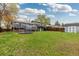 Large backyard with a well-kept lawn, shed, deck, and wood fence at 8506 Eaton St, Arvada, CO 80003