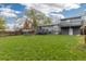 Expansive backyard showcasing a lawn, wood fence, deck, and two-story house at 8506 Eaton St, Arvada, CO 80003