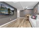 Finished basement area offers neutral paint, durable floors, and entertainment space with TV and foosball table at 8506 Eaton St, Arvada, CO 80003