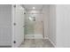 This bathroom features walk-in shower with a frameless glass door at 8506 Eaton St, Arvada, CO 80003