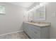 The updated bathroom features double sinks, neutral walls and flooring at 8506 Eaton St, Arvada, CO 80003