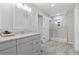 Modern bathroom features a walk-in shower with frameless glass door at 8506 Eaton St, Arvada, CO 80003