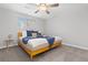 Comfortable bedroom features a ceiling fan, neutral walls, soft carpet, and bright window at 8506 Eaton St, Arvada, CO 80003