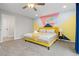 Stylized bedroom showcasing colorful accent wall, plush carpet and decor at 8506 Eaton St, Arvada, CO 80003
