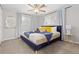 Bright bedroom boasts natural light, modern ceiling fan, neutral walls, and plush carpet at 8506 Eaton St, Arvada, CO 80003