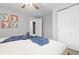Cozy bedroom features a ceiling fan, artwork, soft carpet, and closet for storage at 8506 Eaton St, Arvada, CO 80003