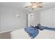 Neutral bedroom offers soft carpet, ceiling fan, closet and an ensuite bathroom at 8506 Eaton St, Arvada, CO 80003