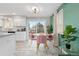 Bright dining area with a sliding door, stylish light fixture, and comfortable seating at 8506 Eaton St, Arvada, CO 80003