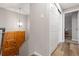 Bright entryway featuring a wooden door, white walls, and a stylish light fixture at 8506 Eaton St, Arvada, CO 80003
