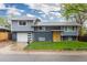 Charming two-story home with a well-manicured front yard and a two car garage at 8506 Eaton St, Arvada, CO 80003