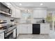 Well-appointed kitchen features stainless steel appliances, white subway tile, and granite countertops at 8506 Eaton St, Arvada, CO 80003