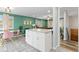 Open kitchen with granite island flowing into dining area and living space at 8506 Eaton St, Arvada, CO 80003