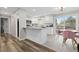 Modern kitchen featuring white cabinets, stainless steel appliances, and a breakfast bar at 8506 Eaton St, Arvada, CO 80003