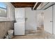Functional laundry room offers washer, dryer, utility sink, and storage space at 8506 Eaton St, Arvada, CO 80003