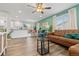 Bright living room with hardwood floors, comfortable seating, and an open layout at 8506 Eaton St, Arvada, CO 80003