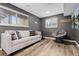 The living room features a sofa, side chairs, laminate flooring and a unique modern vibe at 8506 Eaton St, Arvada, CO 80003