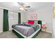 Cozy bedroom with a modern ceiling fan, plush bed, and bright natural light at 8506 Eaton St, Arvada, CO 80003