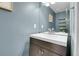 Modern half-bath features blue walls, a large mirror, and a vessel sink at 9615 W Chatfield Ave # C, Littleton, CO 80128