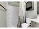 Bathroom with white shower, gray vanity and a patterned shower curtain at 9615 W Chatfield Ave # C, Littleton, CO 80128
