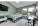 Cozy bedroom featuring two bright windows, a desk, and a lounge chair at 9615 W Chatfield Ave # C, Littleton, CO 80128