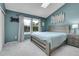 Cozy bedroom with blue walls, neutral carpet, a comfortable bed, and matching bedside tables at 9615 W Chatfield Ave # C, Littleton, CO 80128