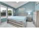 Bedroom featuring light blue walls, a gray wood bed frame, and bright windows at 9615 W Chatfield Ave # C, Littleton, CO 80128
