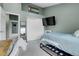Bedroom features a television, closet, and light-filled view into the attached room at 9615 W Chatfield Ave # C, Littleton, CO 80128