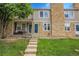 Charming townhouse featuring stone accents, lush lawn, and inviting front porch at 9615 W Chatfield Ave # C, Littleton, CO 80128