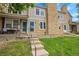 Charming townhouse featuring stone accents, lush lawn, and inviting front porch at 9615 W Chatfield Ave # C, Littleton, CO 80128
