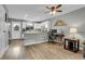 Bright kitchen with white cabinetry and stainless appliances adjacent to living room at 9615 W Chatfield Ave # C, Littleton, CO 80128