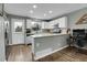 Bright kitchen with white cabinetry and stainless appliances adjacent to living room at 9615 W Chatfield Ave # C, Littleton, CO 80128
