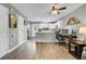 Bright kitchen with white cabinetry and stainless appliances adjacent to living room at 9615 W Chatfield Ave # C, Littleton, CO 80128