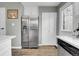 Kitchen features stainless steel refrigerator, white cabinets, and wood-style flooring at 9615 W Chatfield Ave # C, Littleton, CO 80128